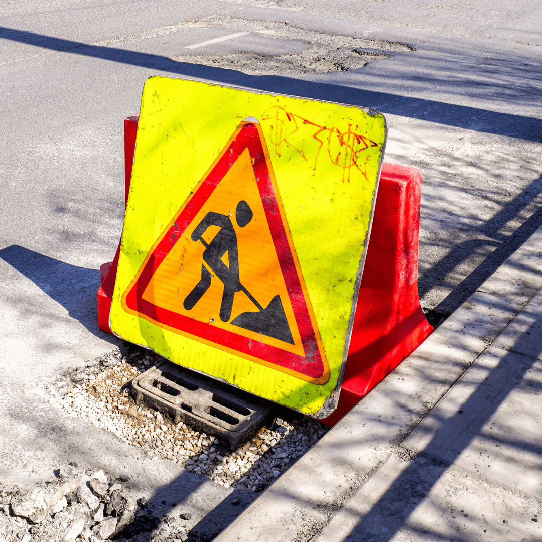 A photograph of a construction sign on a road