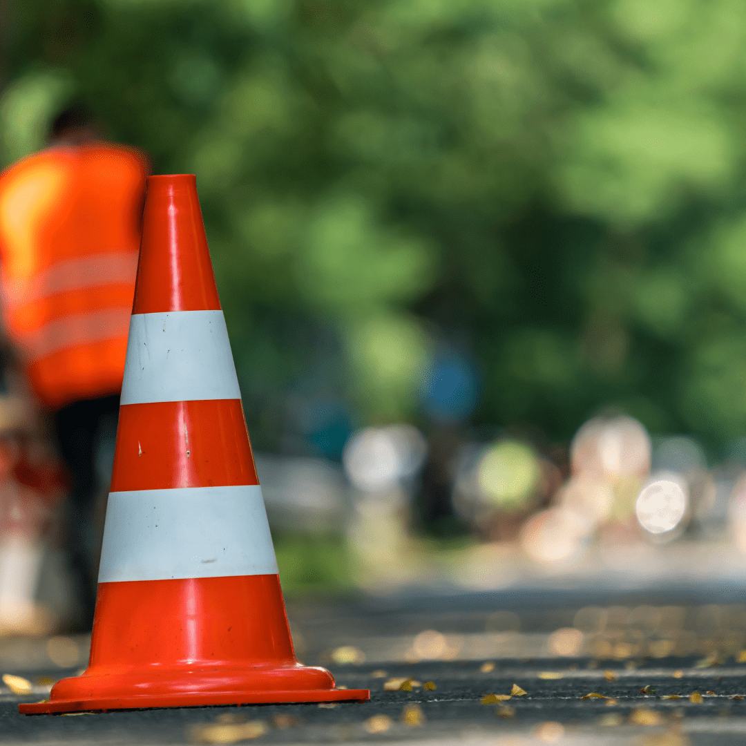 An orange pylon can be seen place on what appears to be a road