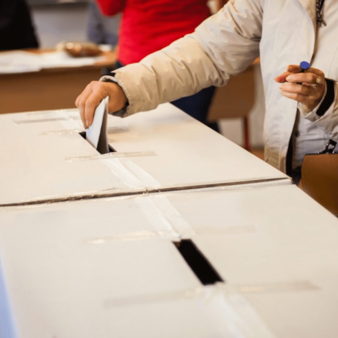A ballot is deposited into a ballot drop box