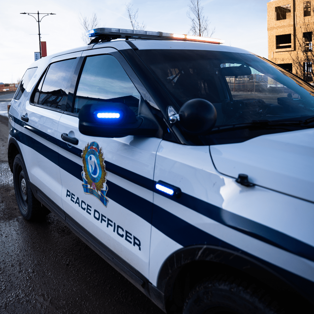 A Community Peace Officer's Vehicle with red and blue lights flashing
