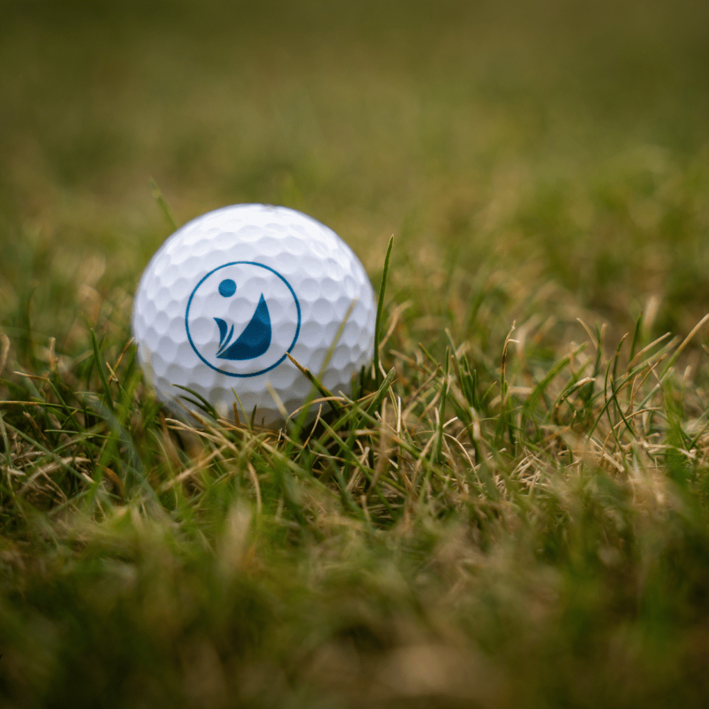 A golf ball on the green with the City of Chestermere logo